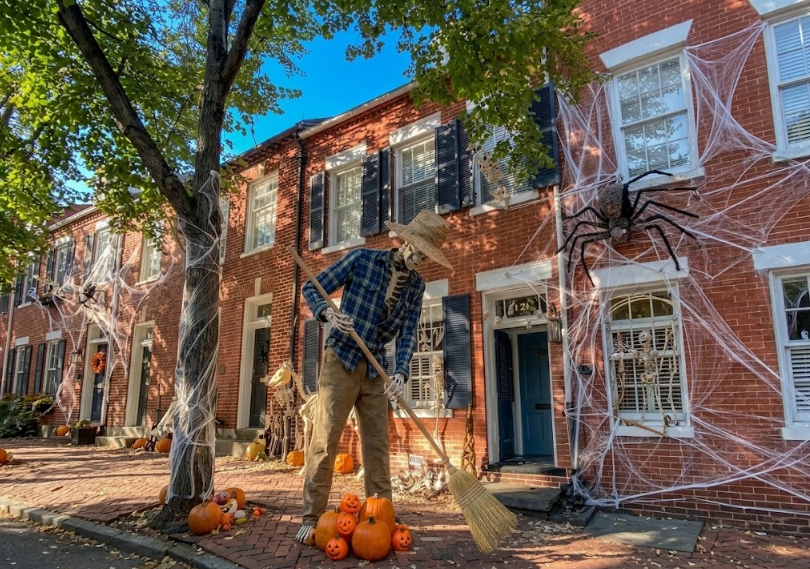Halloween cleanup scene with a tall skeleton dressed in an everyday outfi